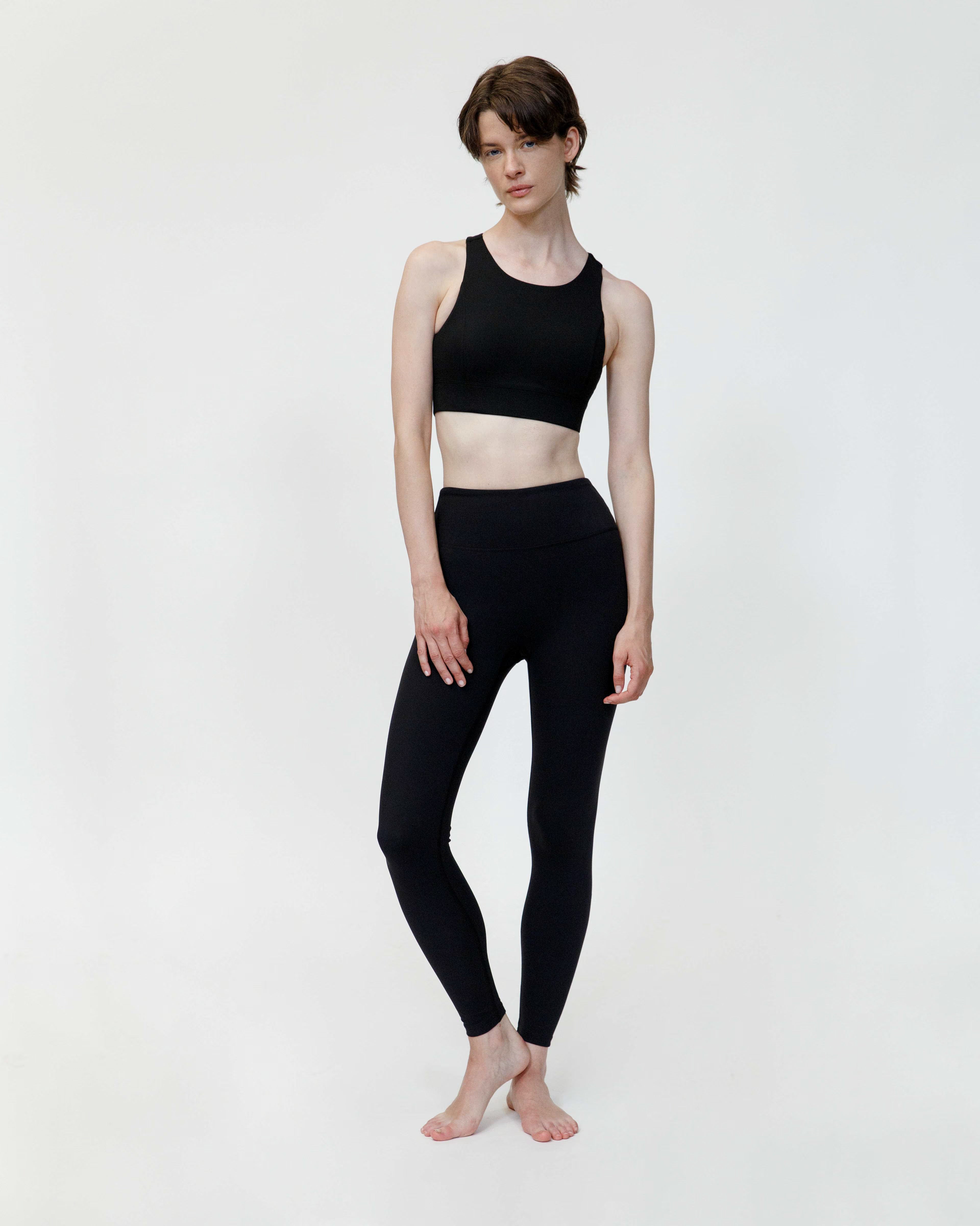 Person wearing a black athletic outfit on a white background