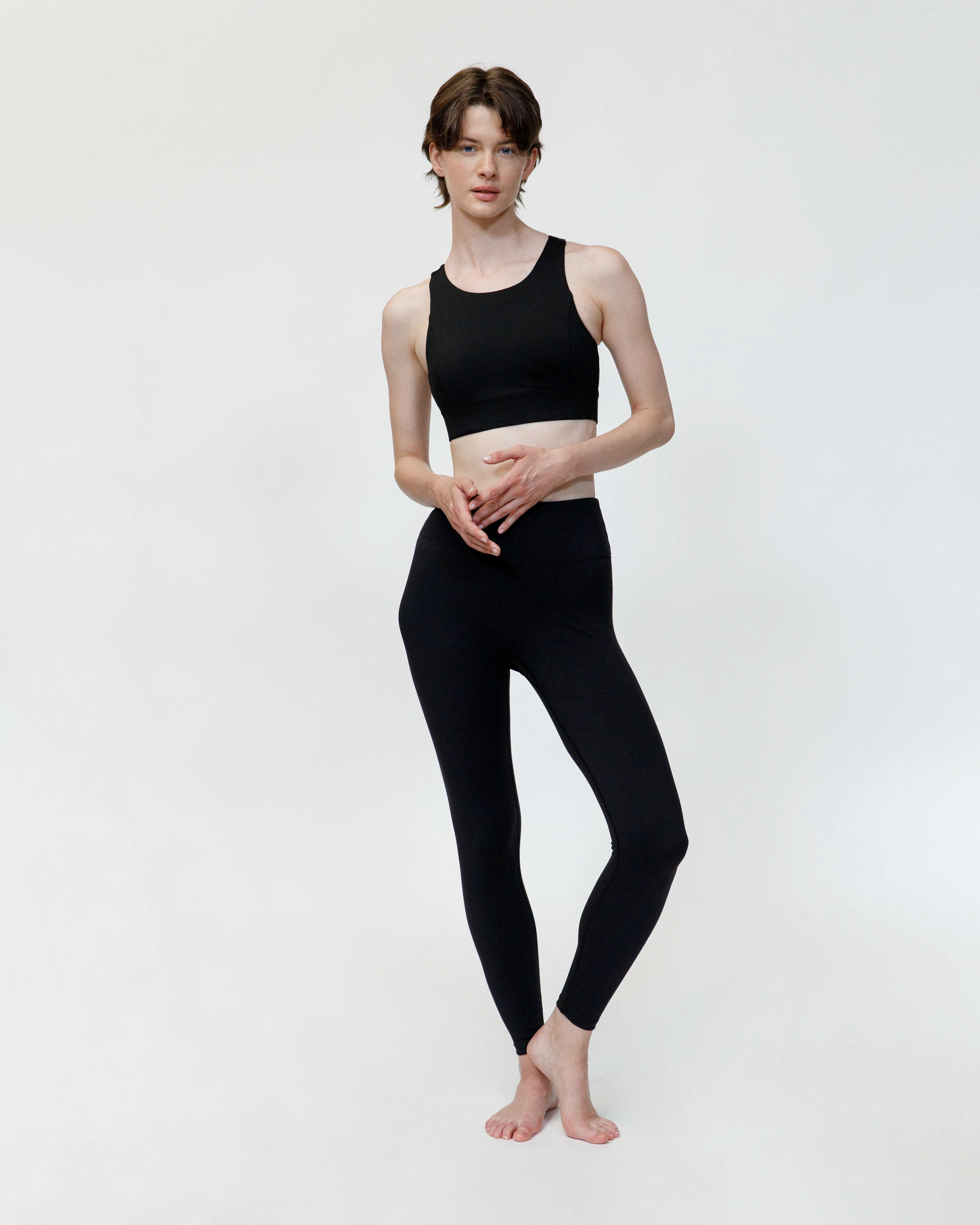Person wearing a black athletic outfit on a white background